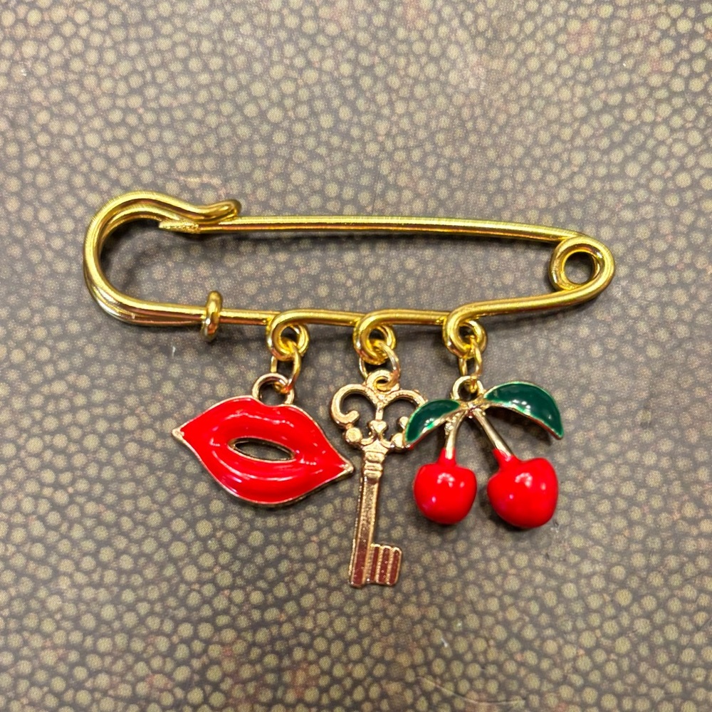 Charming Gold Brooch with Red and Green Accents